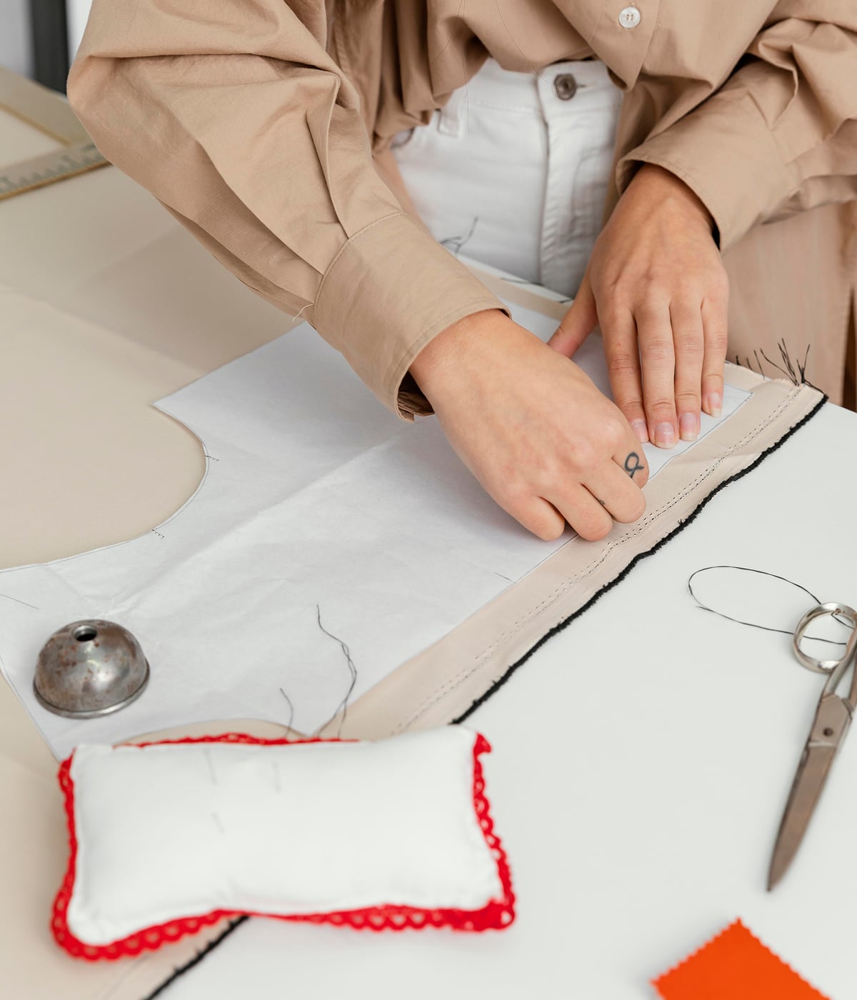 Fashion designer working in her workshop, creating exclusive designs with meticulous attention to detail. Temera technology supports every stage of the cre